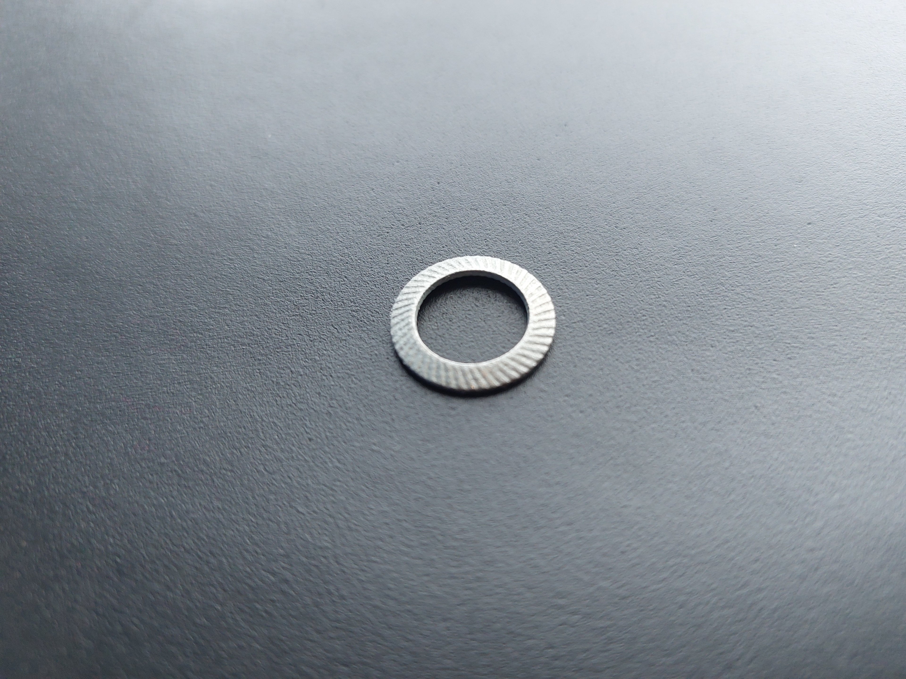 Lock washer, galvanised, outer ø 16 mm, inner ø 10.5 mm.